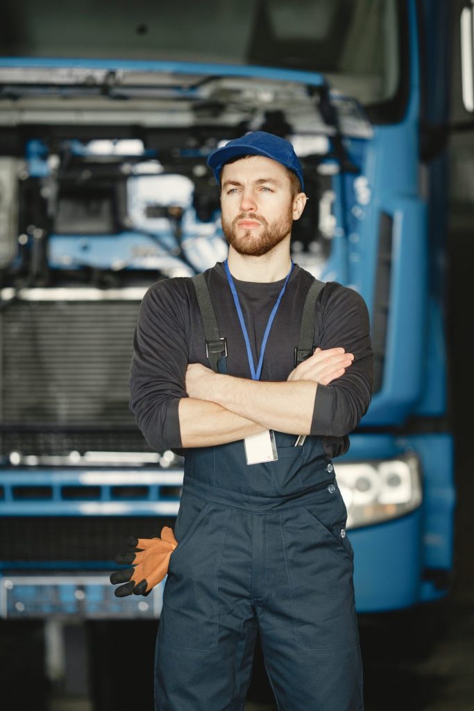 young worker posing infront of truck